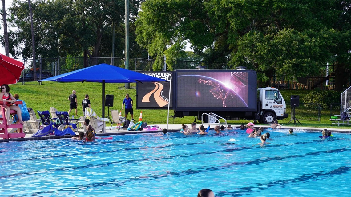 people in the pool watching a movie